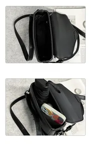 Detail view of the black PU leather crossbody bag interior showing phone and umbrella storage