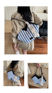 Detail view of large striped canvas tote bag with contrast black piping and durable handles
