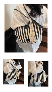 Detail view of large striped canvas tote bag with V-shaped opening and woven logo strap