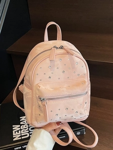 Pink velvet mini backpack with quilted stitching and rhinestones in high quality photography