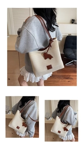 Close-up of cream knit tote bag with brown leather strap and cute bear charm
