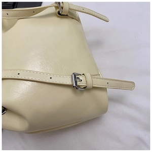 Detail of cream leather texture with neat stitching and silver metal buckle adjustment
