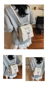 Detail of cream PU leather backpack featuring lace-up design and pearl bow charm detail