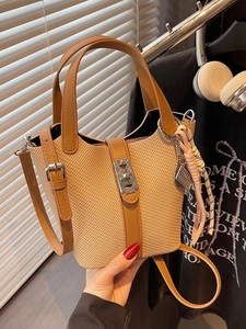 Woven bucket handbag with brown leather trim and silver abacus charm detail