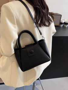 Black litchi grain bucket bag with top handle and adjustable strap for women
