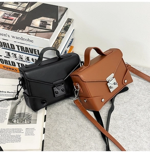 Close-up of vintage PU leather small crossbody bags with metallic lock and rivet details