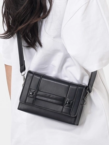 Minimalist black faux leather rectangular crossbody bag with dual vertical rivet straps