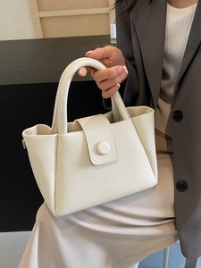 Minimalist cream white lychee leather bucket handbag with top handle and round buckle