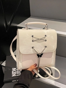 Fashionable beige synthetic leather backpack with silver chain and butterfly pendant
