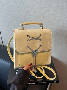 Fashionable beige backpack for women with metal butterfly pendant and pearl detail