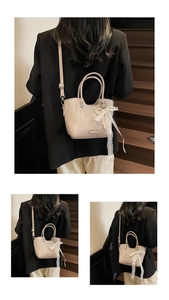 Détail du sac en cuir abricot avec nœud en dentelle perlée et plaque en métal