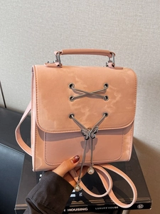 Pink trendy backpack for women with butterfly buckle and pearl charms on art book