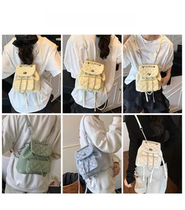 Quilted faux leather mini backpack with metal twist lock and chain straps shown on model