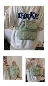 Detail showing mint green quilted leather backpack with chain straps and metal lock