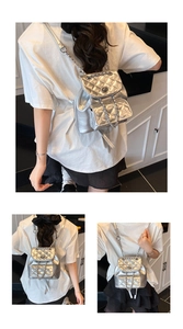 Detail of silver quilted leather mini backpack with metal chain straps and front flap pocket
