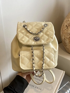 Quilted cream leather mini backpack with metal chain strap and flap closure