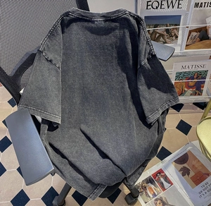 Close-up of stone-washed vintage black oversized cotton t-shirt on an office chair