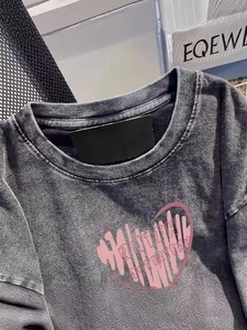 Washed charcoal gray cotton t-shirt featuring a pink heart graphic and vintage texture