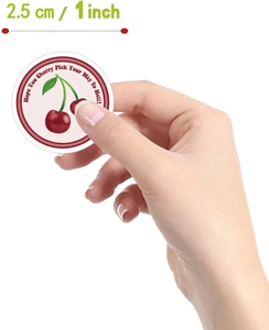 Detailed view of a 2.5cm round waterproof cherry sticker with playful slogan text
