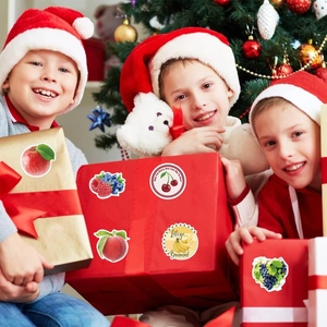 Waterproof fruit stickers with festive packaging scene featuring children and gifts