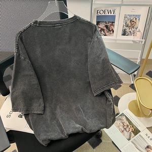 Oversized washed grey cotton t-shirt with vintage streetwear look on clear hanger