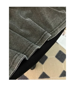Detail of double-needle stitched hem on vintage washed dark gray heavy cotton T-shirt