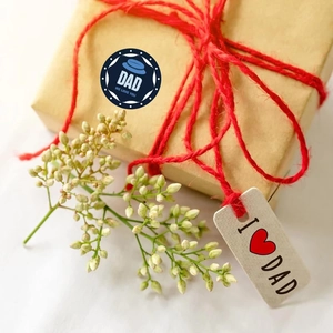 Detail of Father's Day gift box with I Love Dad tag and round seal sticker decoration