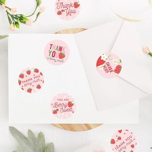Detail of pink strawberry thank you stickers applied on greeting cards and gift envelopes