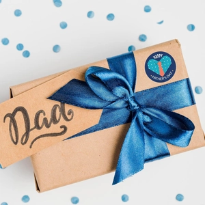Father's Day gift box with blue ribbon, round seal sticker, and a Dad kraft tag detail
