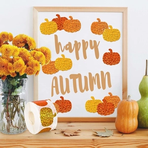 Macro detail of pumpkin shaped glitter stickers on a roll for autumn festival decoration