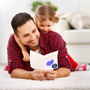 Father's Day Best Dad round sticker applied on a white greeting card in a home setting