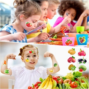 Waterproof cartoon fruit stickers showing strawberry and banana on a child's hand