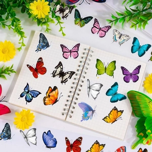 Macro view of butterfly stickers on a grid notebook with decorative floral background
