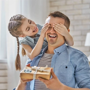 Detail of round Father's Day sticker on kraft gift box with Best Dad text