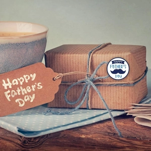 Father's Day round sticker with blue mustache design on brown kraft gift box wrap