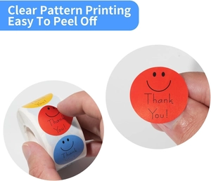 Detail of multi-color smiley face thank you stickers roll being peeled for packaging