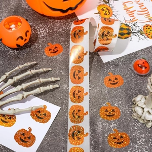 Roll of orange glitter pumpkin stickers for Halloween decorations and envelope seals