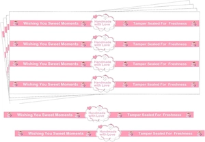 Macro shot of pink heart baking labels with Wishing You Sweet Moments text and icons