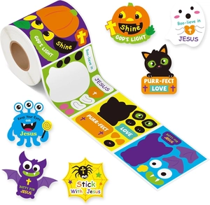 Macro shot of Halloween religious stickers roll with pumpkin, ghost and cross patterns