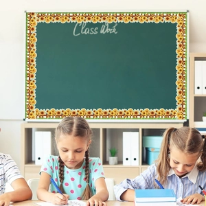 Classroom blackboard decorated with sunflower border stickers showing school scene