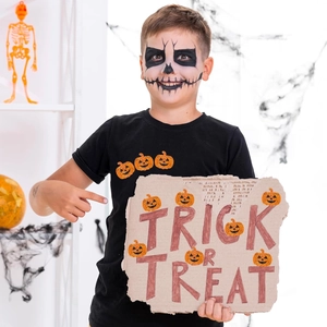Close-up of kids' black Halloween t-shirt with glittery orange pumpkins and spooky makeup