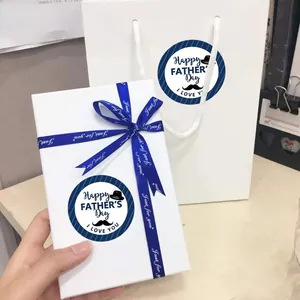Close-up of Father's Day gift box and bag set with blue stickers and ribbons
