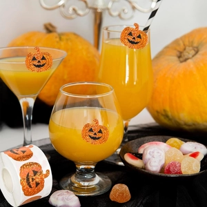 Glitter orange pumpkin face stickers on glasses and gift boxes for Halloween party