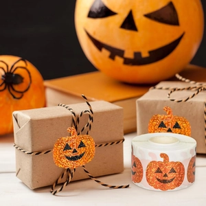 Holographic orange glitter pumpkin sticker sealing a gift box for Halloween decor