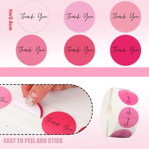 Detailed view of 1-inch pink gradient Thank You stickers in a roll showing easy peeling