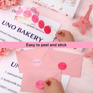 Close-up of pink round Thank You labels for envelope sealing and gift decoration