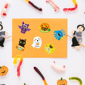 Detail view of Halloween Christian stickers on orange envelope with spooky decorations
