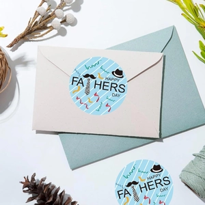 Close-up of Father's Day round stickers with Happy Father's Day text on envelope