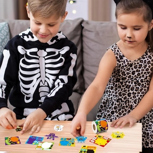 Kids playing with Halloween religious stickers featuring pumpkins, cats and bats at home