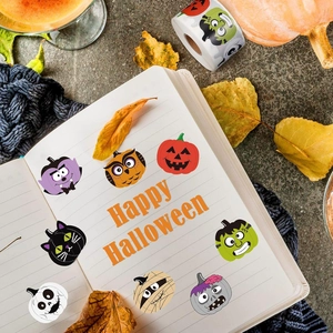 Close-up of Halloween cartoon stickers with pumpkin and vampire designs on a notebook